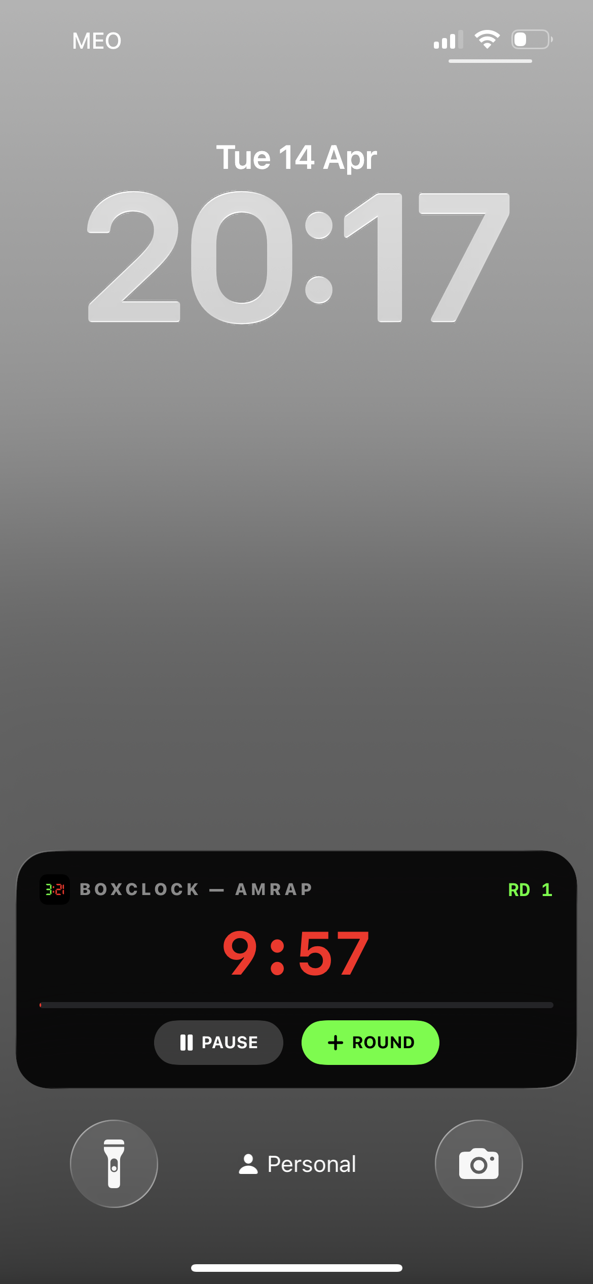 BoxClock Live Activity showing AMRAP timer with round button on lock screen